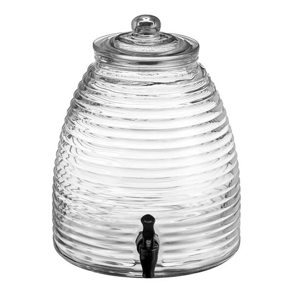 An Acopa glass beverage dispenser with a black tap and lid.