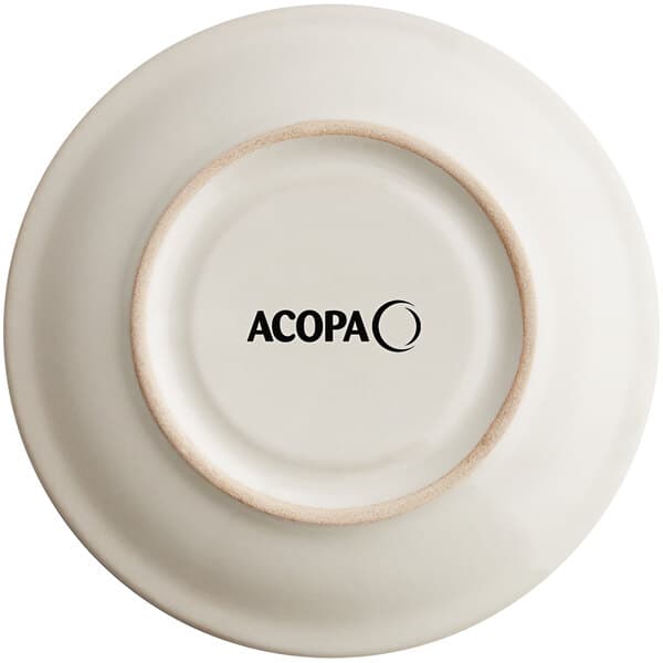 An ivory stoneware saucer with a brown rim and the word Acopa in black text.