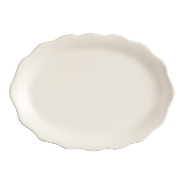 An ivory stoneware oval platter with a scalloped edge.