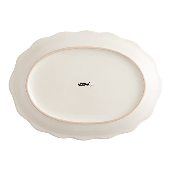 An ivory oval stoneware platter with a scalloped edge.
