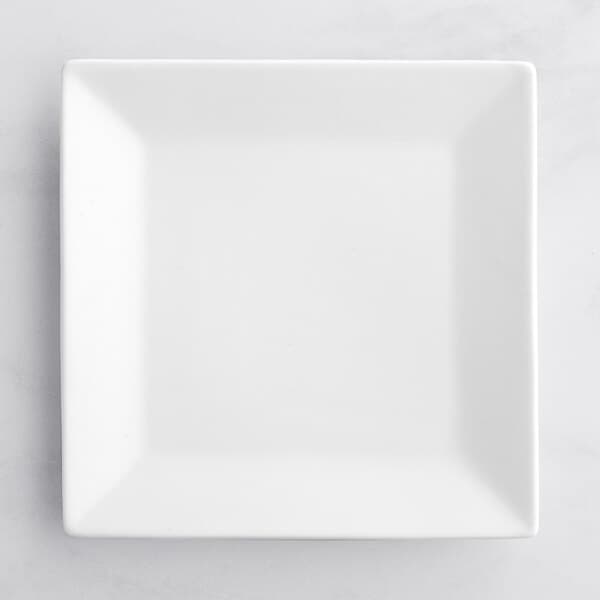 An Acopa bright white square porcelain plate on a white surface.