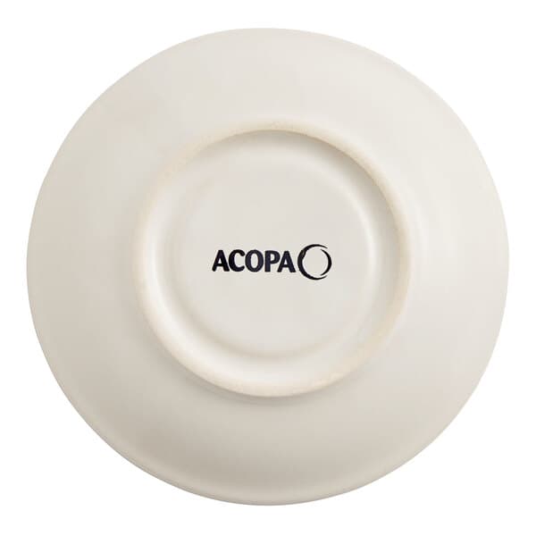 An ivory Acopa saucer with a rolled edge and black text on the rim.