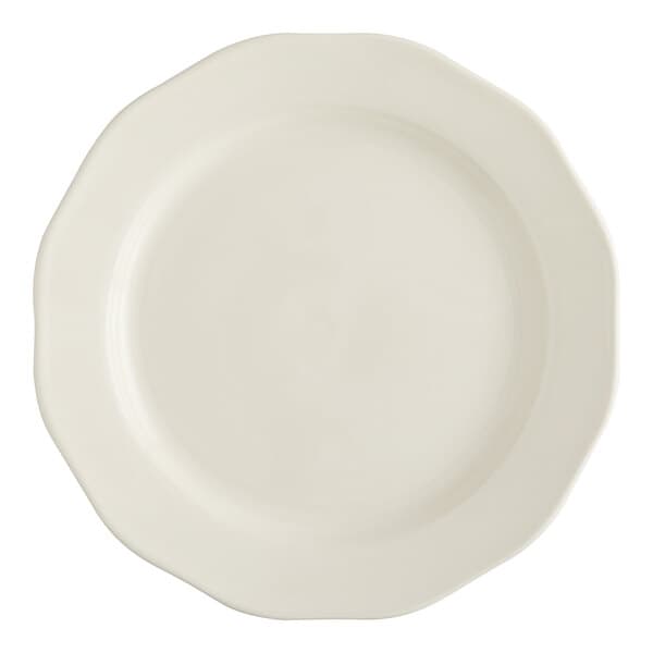 An Acopa ivory stoneware plate with a scalloped edge.