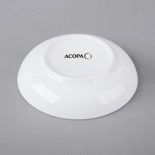 A bright white porcelain round sauce cup with black text that reads "acopa"