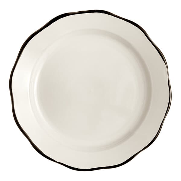 An Acopa ivory stoneware plate with scalloped edges and a black rim.