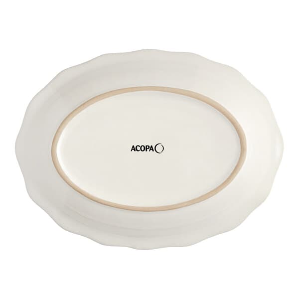 An ivory oval stoneware platter with a scalloped edge.