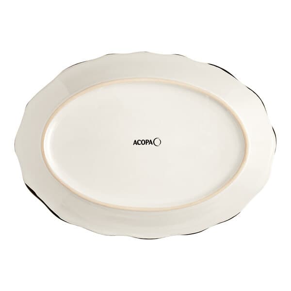 An ivory stoneware oval platter with a scalloped edge and black trim.