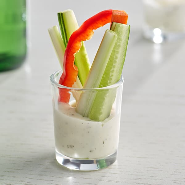 An Acopa shot glass filled with vegetables and dip.