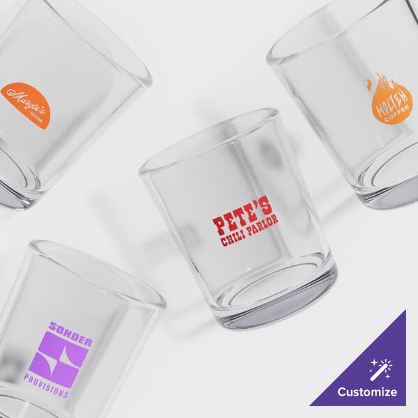 A group of Acopa customizable shot glasses on a white background.