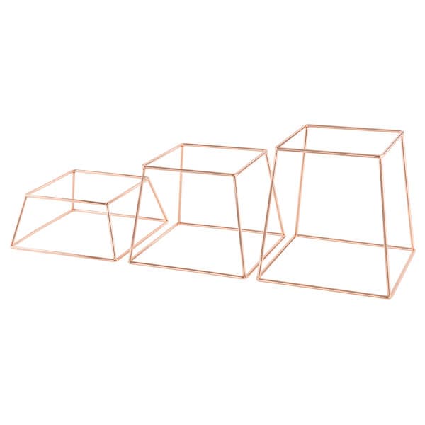 A group of three rose gold metal Acopa display stands with different shapes.
