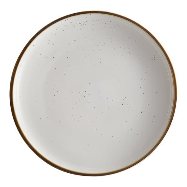 A white Acopa stoneware coupe plate with brown specks on the edges.