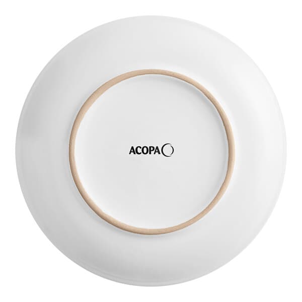 An Acopa matte white stoneware coupe plate with a brown rim.