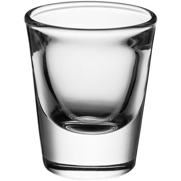 A close up of a clear Acopa shot glass.