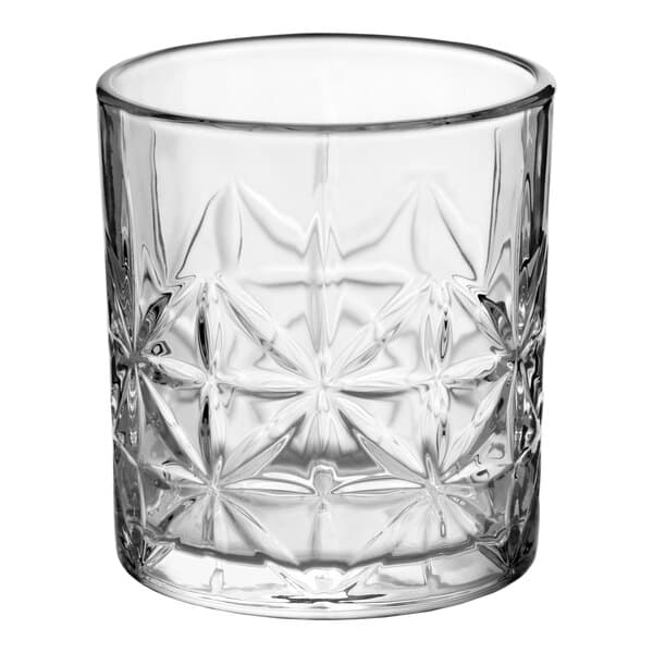 A clear glass with a decorative, textured pattern, designed for serving rocks or old fashioned drinks.