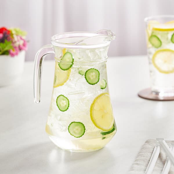 An Acopa glass pitcher of water with lemons and cucumbers.