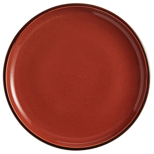 An Acopa Keystone Sedona Orange stoneware coupe plate with a black rim.