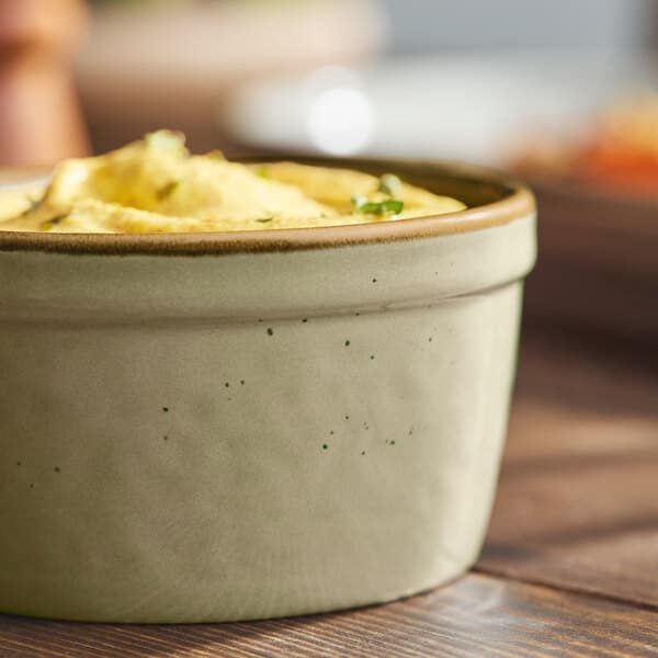 A granite gray stoneware ramekin filled with food.