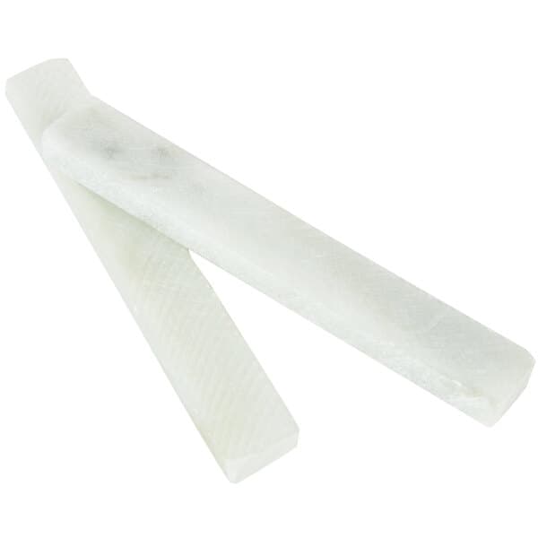 A close-up of a white Acopa Square Slate Coaster with Soapstone Chalk.