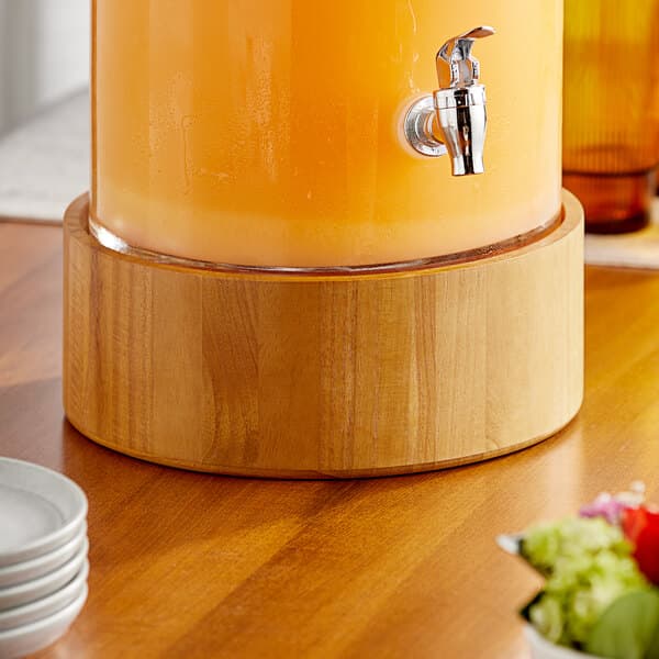 An Acopa glass beverage dispenser on a table.