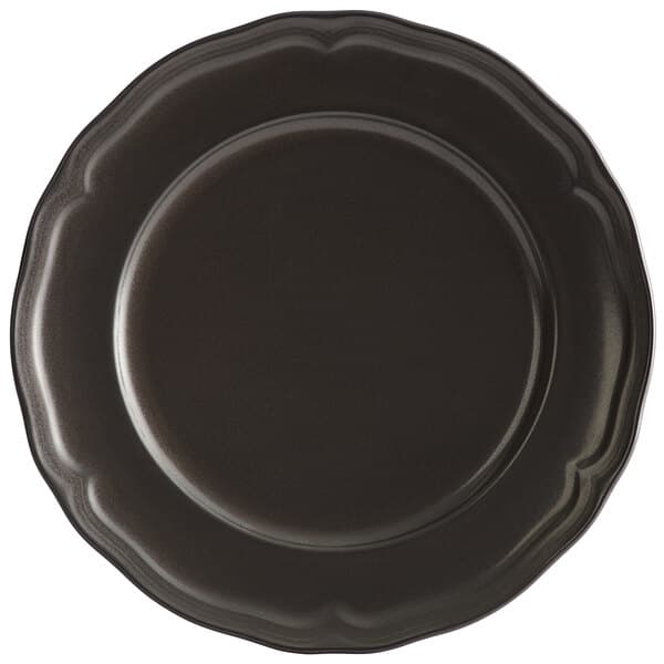 An Acopa Condesa black porcelain plate with a scalloped rim.
