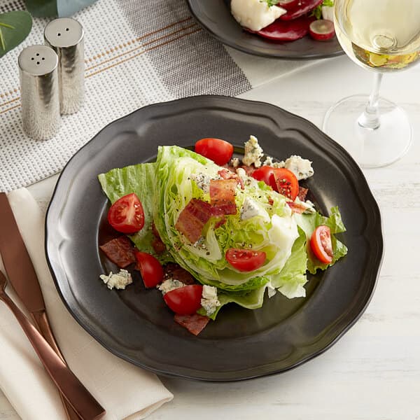 An Acopa Condesa matte gray porcelain plate with a salad of lettuce, tomatoes, and bacon.
