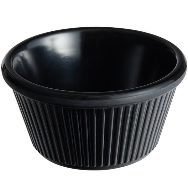 A black fluted Acopa melamine ramekin with a white background.