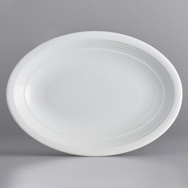An Acopa Capri coconut white oval stoneware coupe platter.