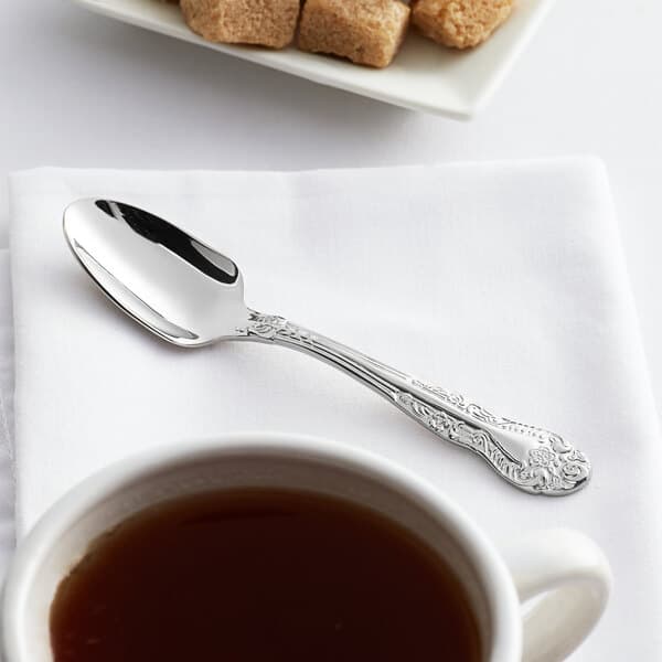 An Acopa stainless steel demitasse spoon in a cup of coffee.