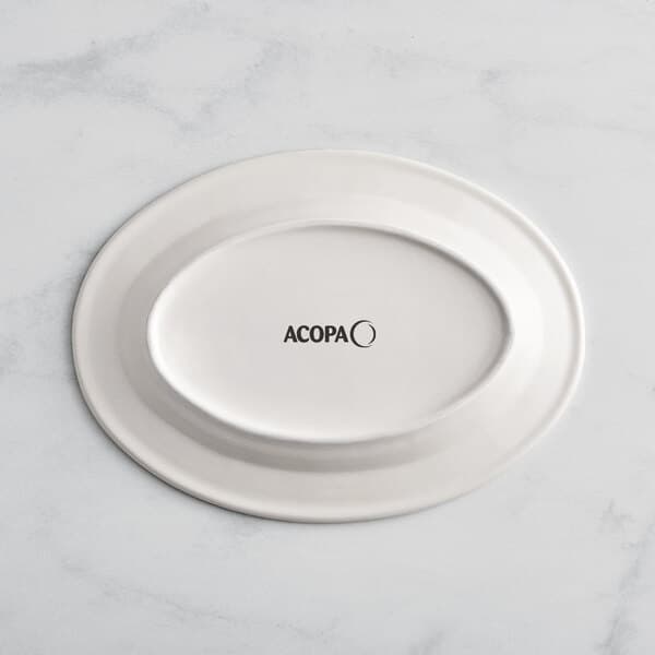 An Acopa ivory stoneware platter with blue bands on the rim.