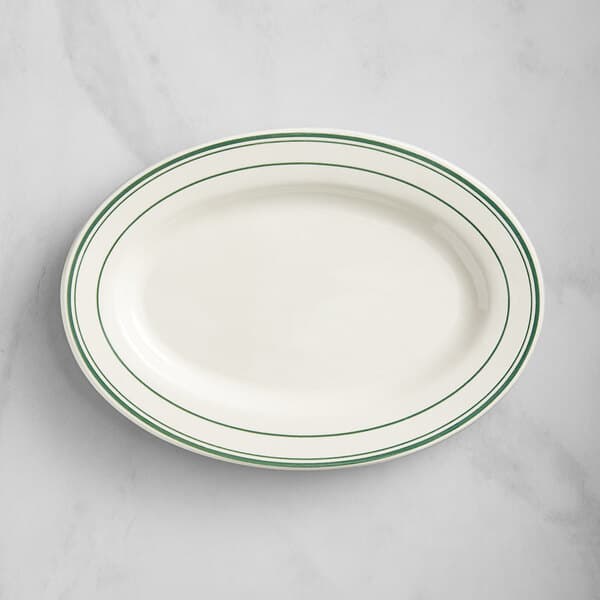 An ivory oval platter with green lines.