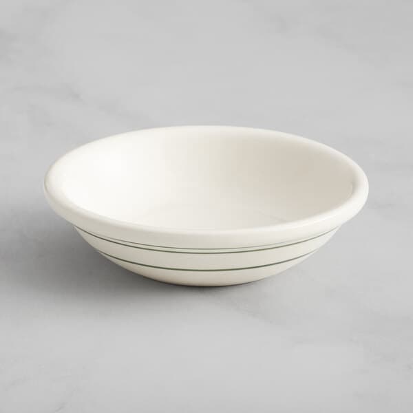 An Acopa ivory stoneware fruit bowl with green lines on it.