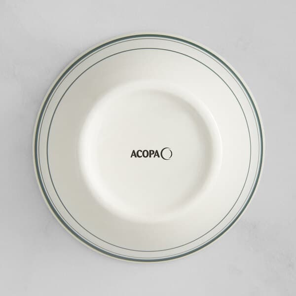 An Acopa ivory stoneware bowl with green bands on the rim.