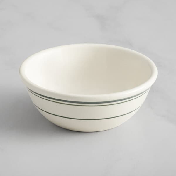 An Acopa ivory stoneware bowl with green lines on it.