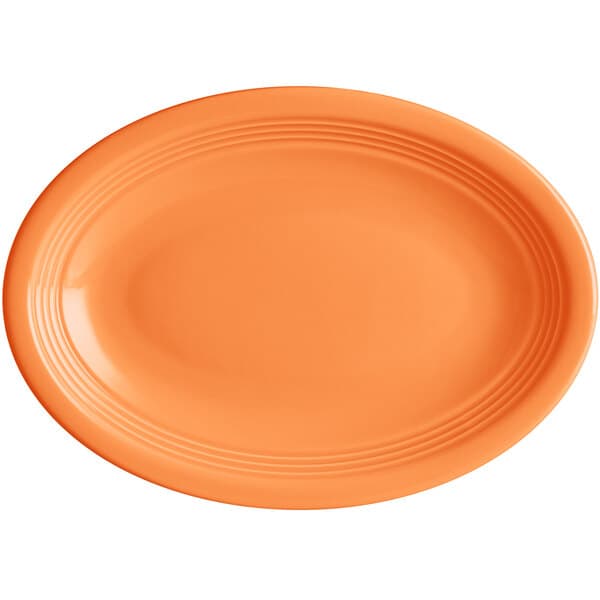 An orange oval stoneware platter with a white background.