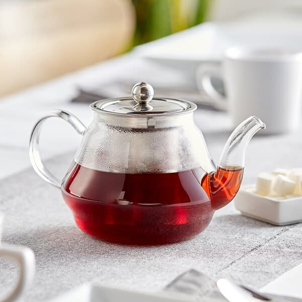 An Acopa glass teapot filled with red liquid.