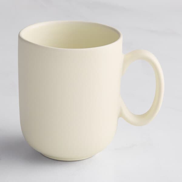 A close up of a white Acopa Pangea mug with a handle.