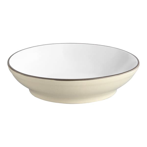 A white stoneware pasta bowl with a brown rim.