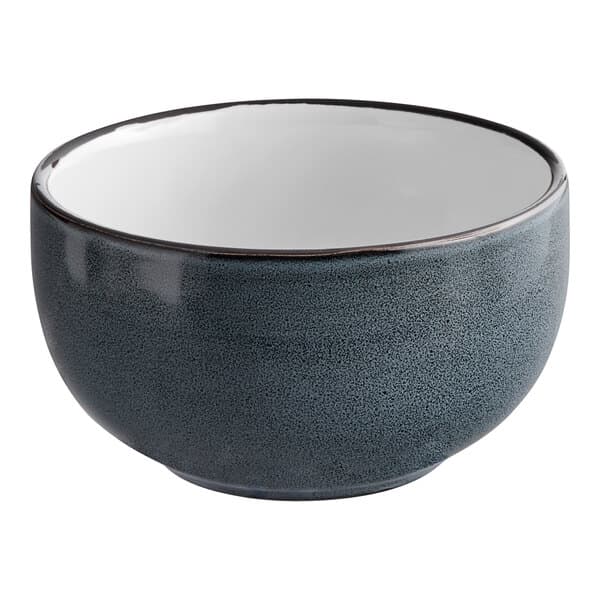 A matte midnight blue stoneware bowl with a white rim.
