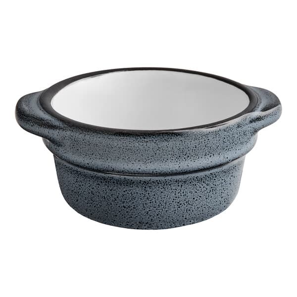 A close up of a Midnight Blue Matte stoneware sauce cup on a kitchen counter.