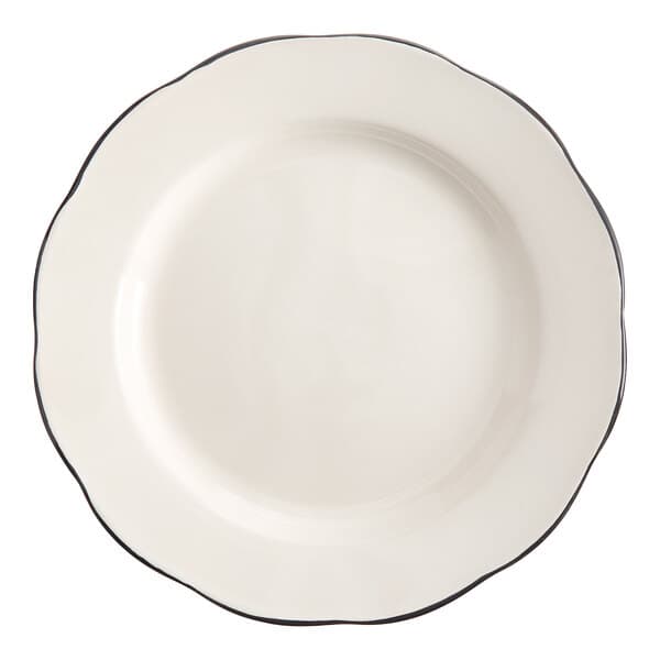 An Acopa ivory stoneware plate with a black scalloped rim.