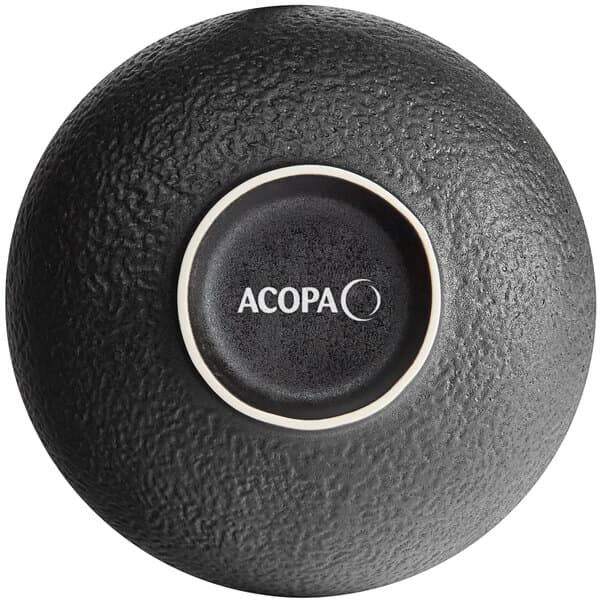 A black Acopa stoneware bowl with white textured text that reads "Acopa" in a circle.