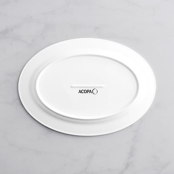 An Acopa Cordelia bright white porcelain platter with an embossed oval rim.