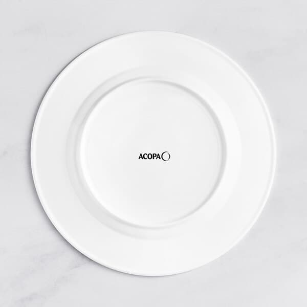 An Acopa Cordelia white porcelain plate with an embossed wide rim and black text on it.
