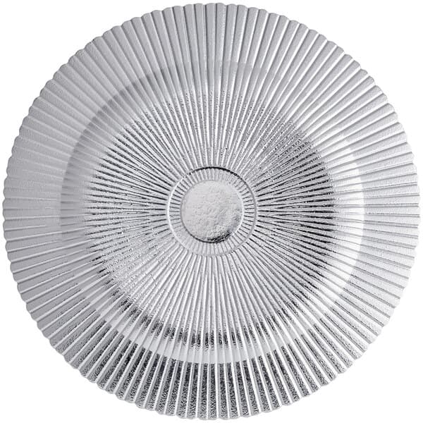A silver charger plate with a circular sunburst design.