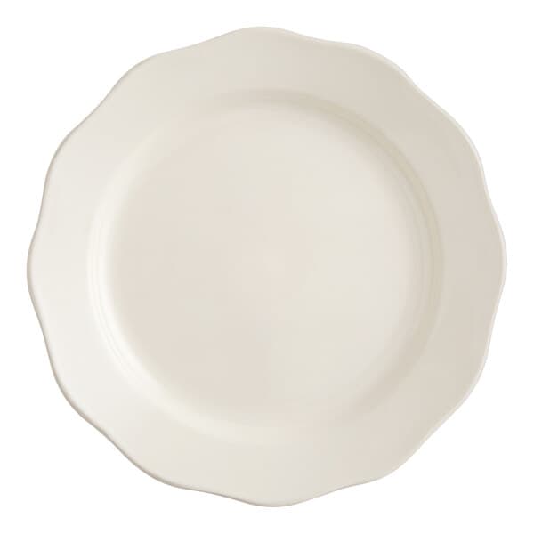 An Acopa ivory stoneware plate with a scalloped edge.