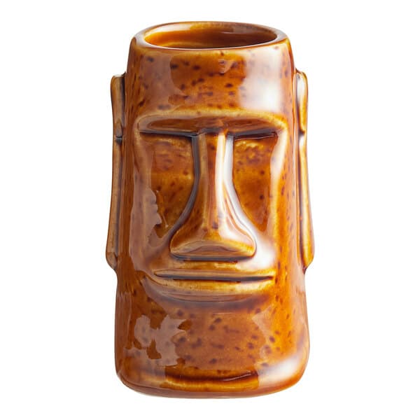 A brown ceramic Acopa Tiki shot glass with a face on it.
