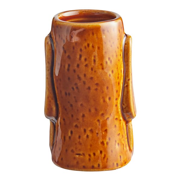 A brown ceramic Acopa Tiki shot glass with a handle.