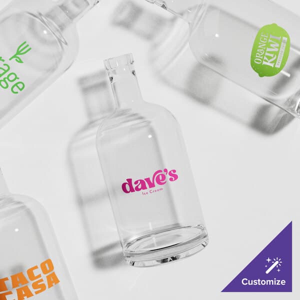 A group of Acopa clear glass bottles with different logos on them.