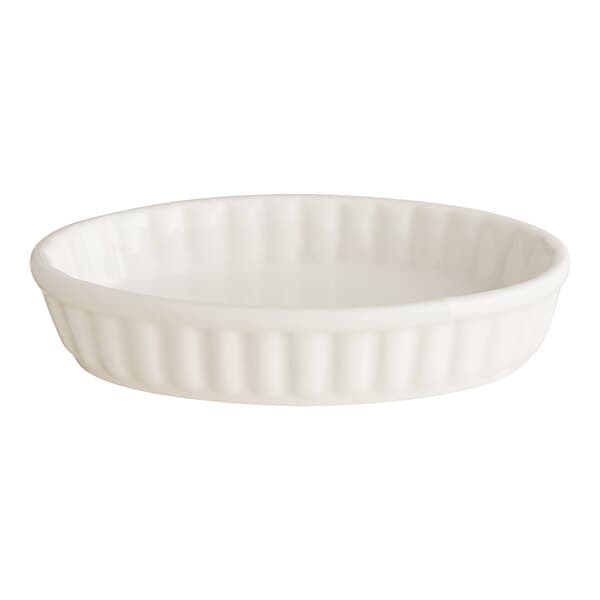An Acopa ivory porcelain oval dish with a ruffled edge.