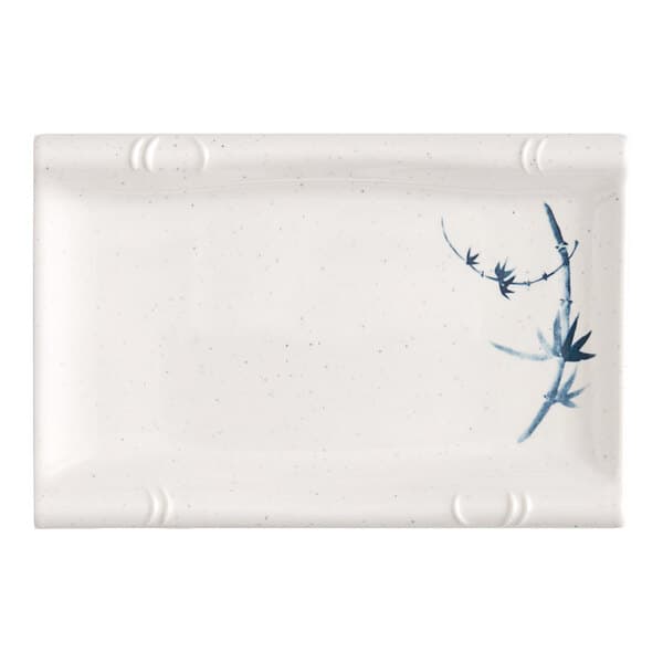 A white rectangular plate with blue bamboo designs.